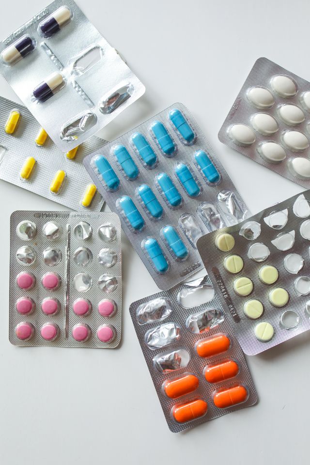 Prescription medication and pill bottles representing drug coverage coordination with Medicare