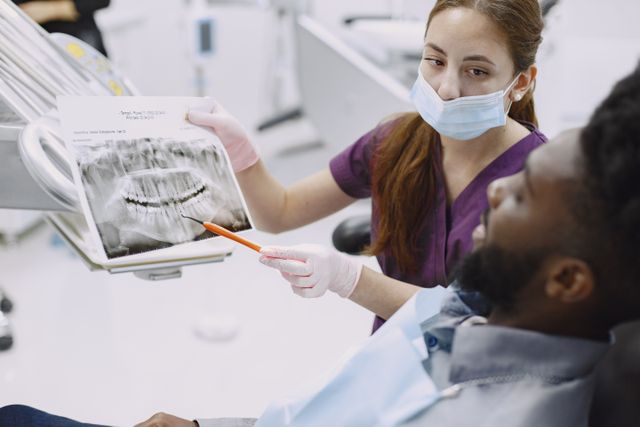 Person calculating the break-even point between two health insurance plan options