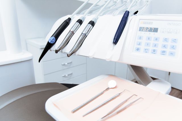 Dentist examining a patient's teeth during a routine dental checkup covered by dental insurance