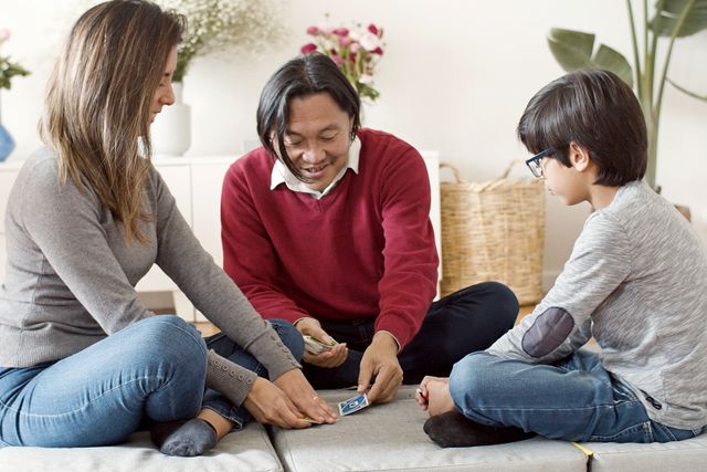Pediatrician examining a child during a well-child visit covered under a family health insurance plan
