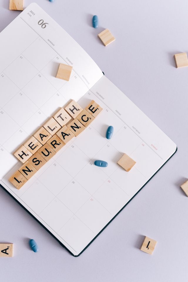 Parent reviewing family health insurance deductible options with a calculator