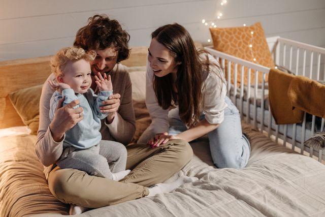 Happy family reviewing their completed health insurance enrollment together at home