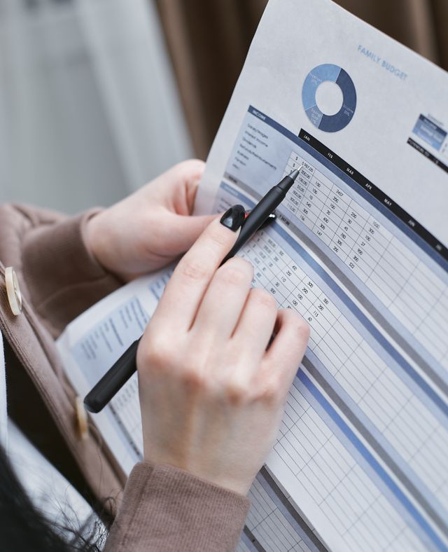 Person calculating Medicare IRMAA surcharge tiers and premium costs