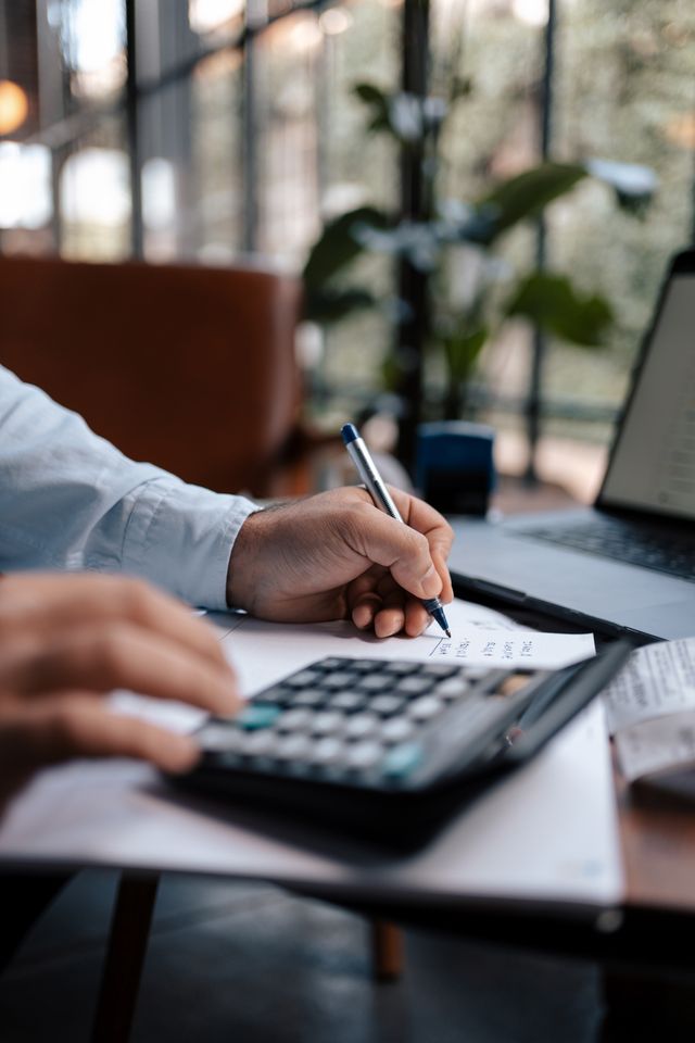 Person calculating the real cost difference between whole life and term life insurance