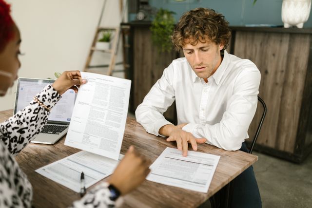 Self-employed worker reviewing 1099 tax forms and income documents for ACA subsidy estimation